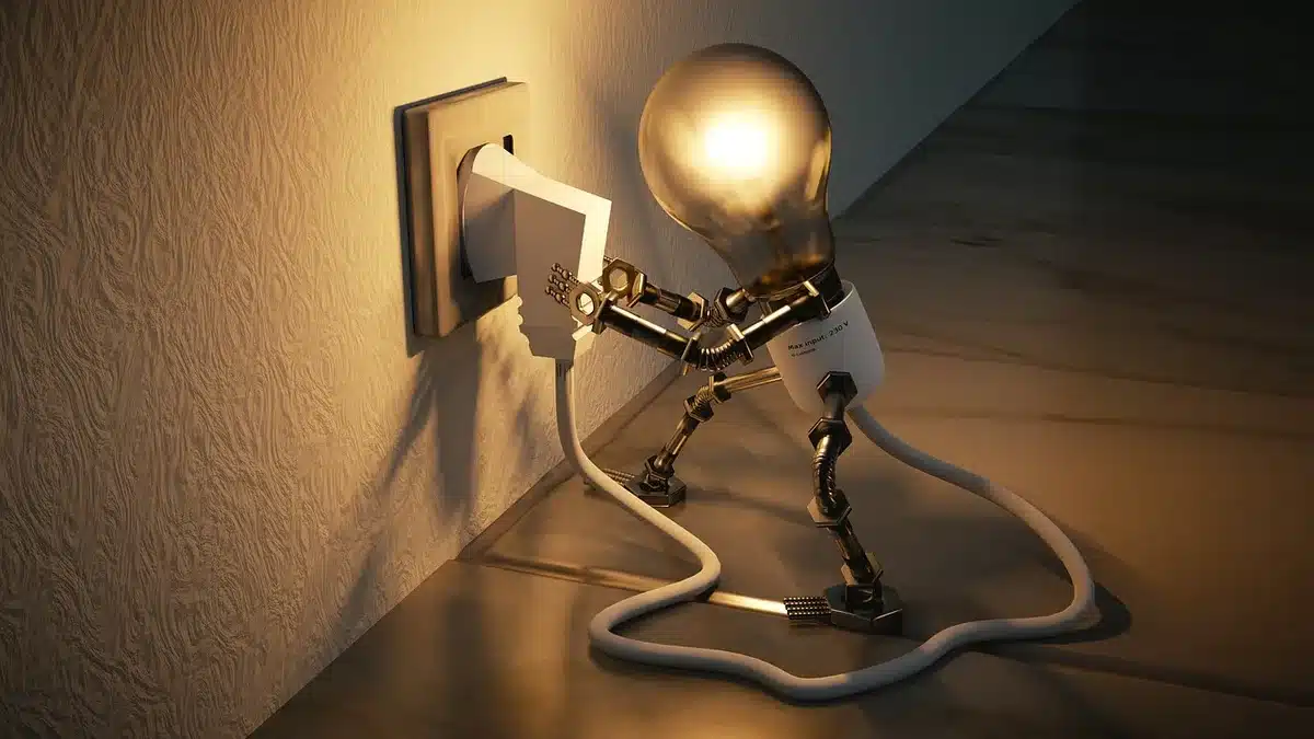 Piccola città rurale con linee elettriche e infrastrutture industriali sullo sfondo