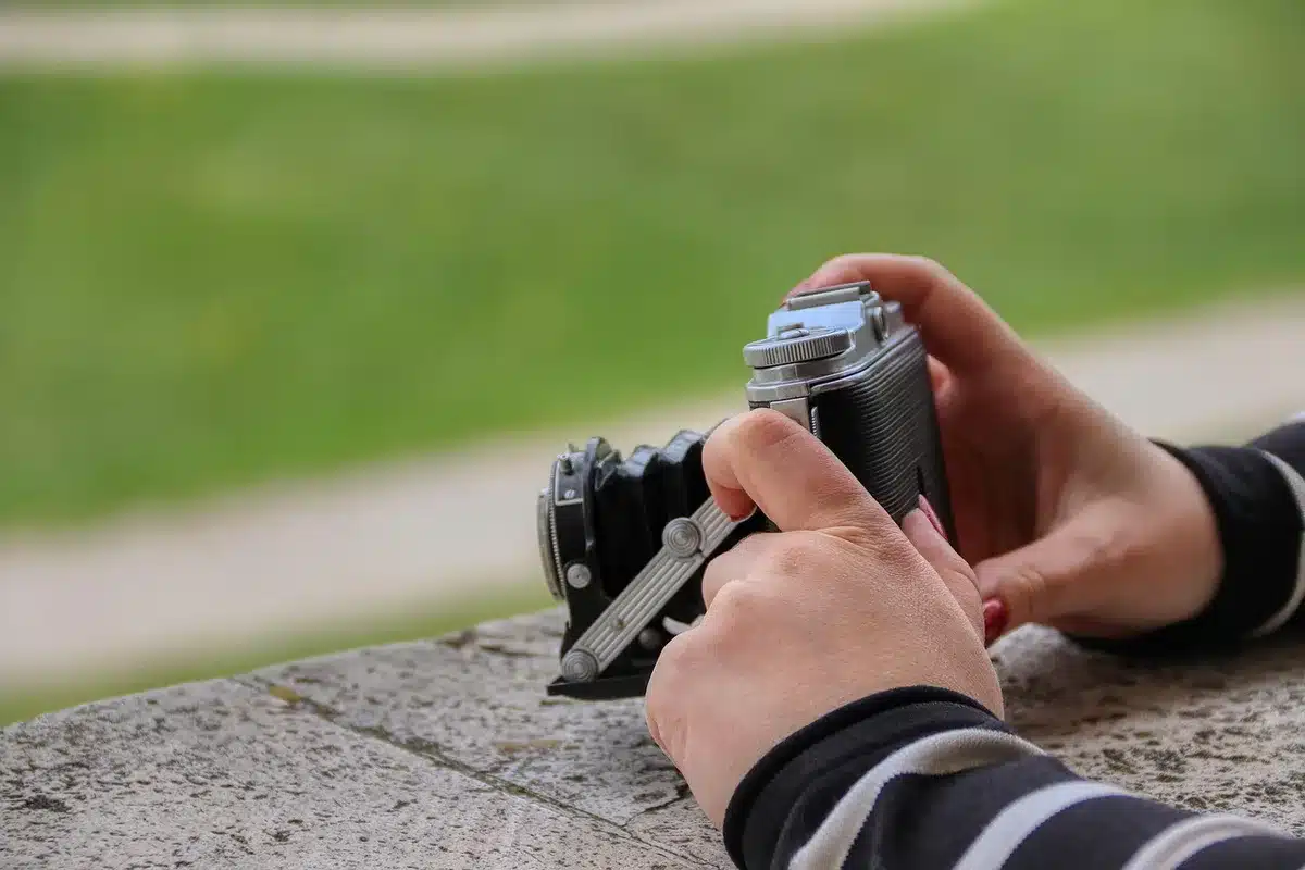 Mano che mostra un lettore portatile connesso a cuffie Bluetooth